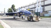 An F18 is transported to the maintenance hangar aboard NAS North Island