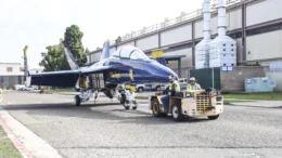 An F18 is transported to the maintenance hangar aboard NAS North Island