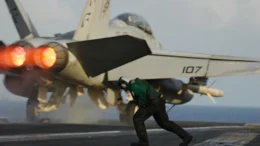 catapult operator runs out after the launch of an F/A-18F Super Hornet